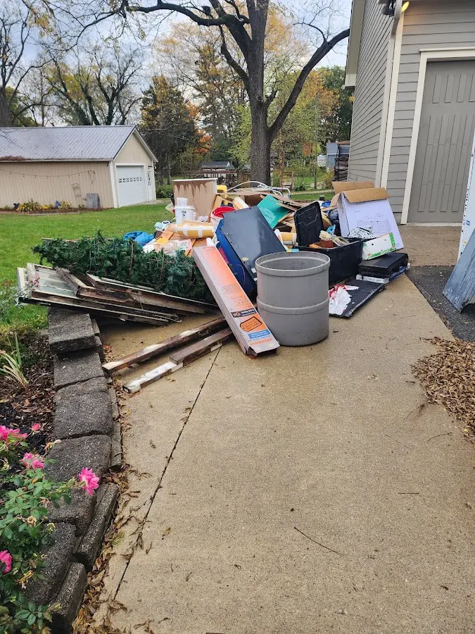 Dumpster being loaded with debris for Residential Dumpster Rental in Plano